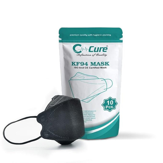 A black C-CURE KF94 face mask with a 3D design, displayed next to its packaging which is predominantly white with green accents.