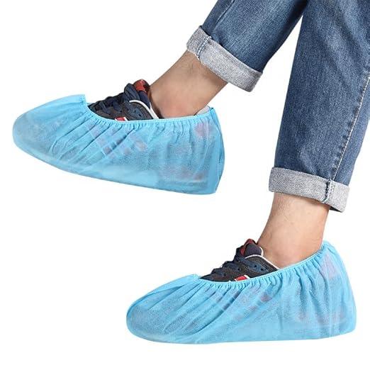 Blue non woven shoe covers being worn over sneakers
