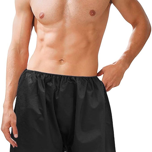 A person wearing black disposable non-woven bermuda shorts with an elastic waistband.