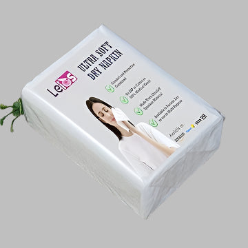 pack of Ultra Soft Dry Napkins with a woman using a napkin on a gray background